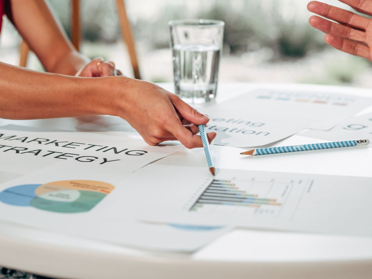 Home Hands discussing marketing strategy with charts in an office setting.